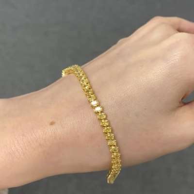 Natural Fancy Yellow VS-SI Clarity Oval Shape Tennis Bracelet in 18k Yellow Gold.