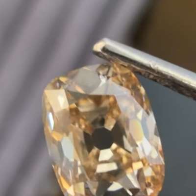 A 1.25cts GIA certified natural fancy light yellowish brown VS1 old cut cushion shape diamond that instantly draws you in. 