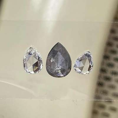 2.37ct layout is such an artistic mix is a striking salt and pepper diamond of 1.46cts in the center, paired beautifully with two contrasting pear rosecuts, one 0.52ct in I color SI1 clarity and the other 0.39ct in H color VS2 clarity. 