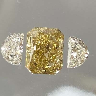  1.15cts GIA certified natural fancy brownish yellow radiant cut,A perfectly matched pair of half-moon side stones — G color, VVS2 clarity, and beautifully clean. 