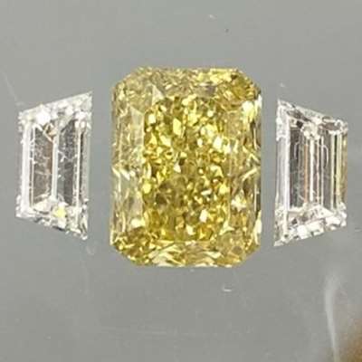 1.57cts GIA certified Natural Fancy Brownish Yellow Radiant Shape Diamond, paired with 0.46cts of EF color, VVS-VS clarity Trapezoid Shape Diamonds as shoulder stones.