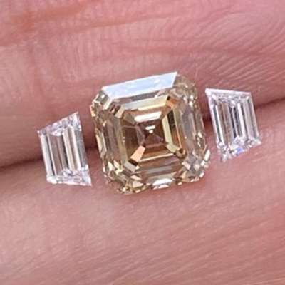 1.46cts Natural Peachy Brown VVS2 clarity Asscher Cut Diamond paired with 0.29cts total weight Natural FG color VVS-VS clarity Trapezoid Shape Shoulder Stones