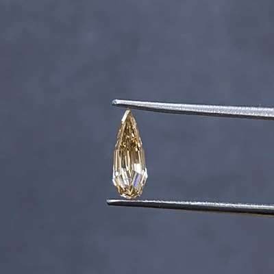 A super long 0.38cts champagne brown i1 clarity step cut pear shape diamond. Its a rare find with a 8.94mm length