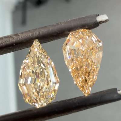 1.06ct GIA Certified Natural N Color VS1 Clarity Step Cut Pear Shape Diamond Along With 1.11ct Natural Honey Brown VVS2 Clarity Step Cut Pear Shape Diamond.