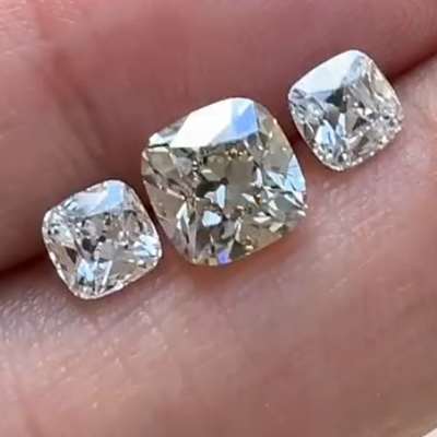 1.58ct Fancy Light Brown Yellow SI1 Old Miner Cut Diamond , flanked by matching pair of 0.51ct G VVS2 and 0.52ct H VS1 Old Miner Cut Diamonds